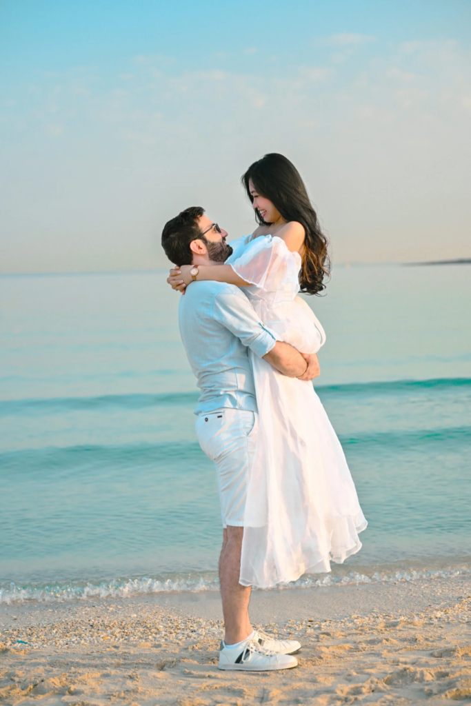 Pre wedding photography in Dubai featuring a couple sharing a romantic moment on the beach