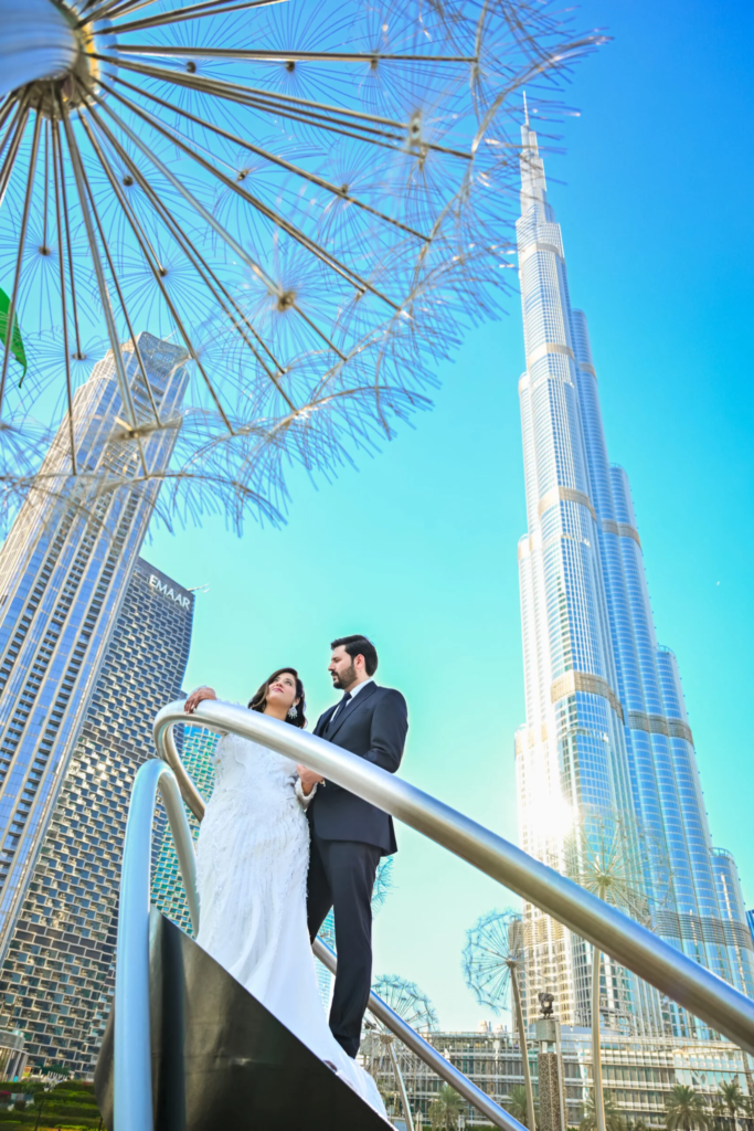 Pre wedding photography in Dubai featuring a couple posing with Burj Khalifa in Downtown Dubai