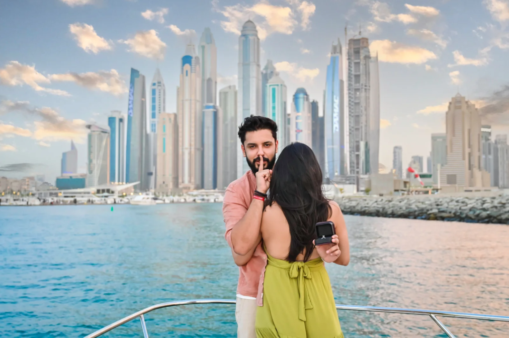 Pre wedding photography in Dubai featuring a couple on a yacht with the Dubai Marina skyline